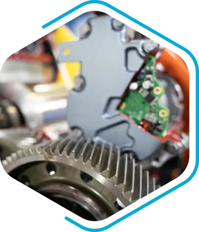 Close-up view of mechanical gears and an exposed circuit board, with a hexagonal frame and a blue outline.
